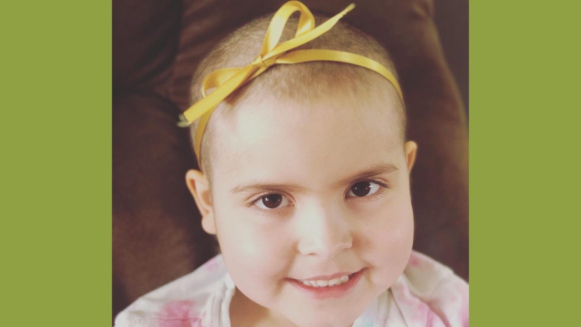 Era posing with a gold ribbon on her head