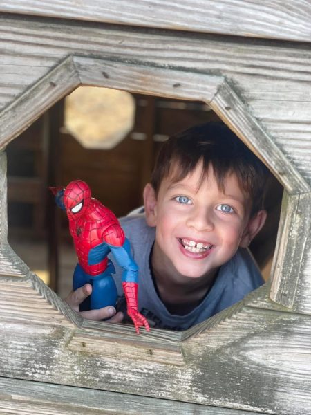Lincoln playing with a spiderman figurine
